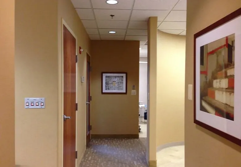 A corridor inside Davidson Dental Associates, hung with framed artwork.