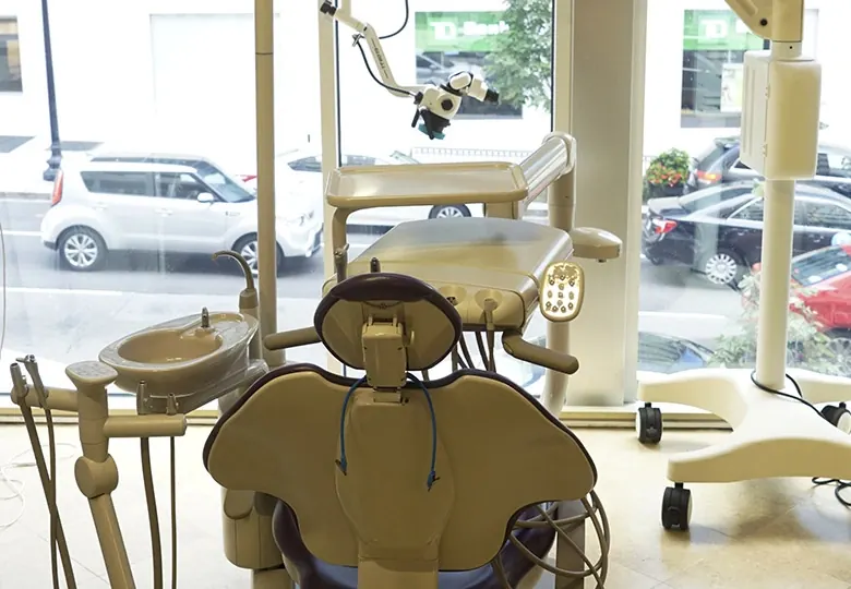 A treatment room at Davidson Dental Associates with a dental operating microscope beside the chair.