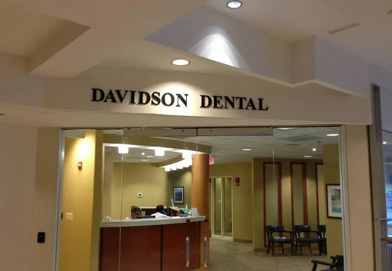 The front desk at Davidson Dental Associates, seen through the glass entrance.