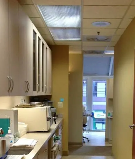 The clinical corridor at Davidson Dental Associates, with cabinets and sterilisation equipment.