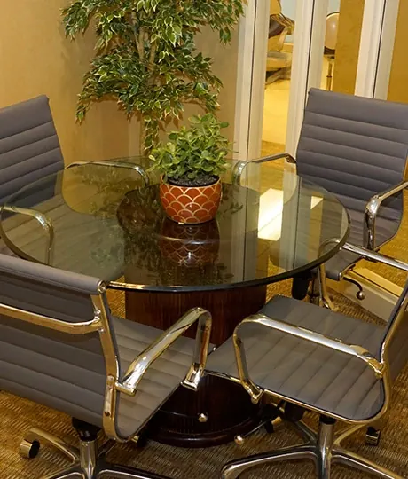 A consultation table with chairs and plants at Davidson Dental Associates.